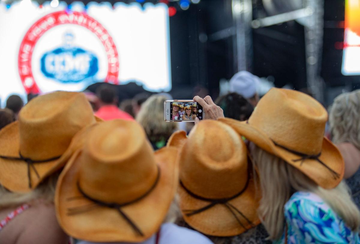 Mickey Maguire of Boston, MA. (L), Erin Romano of Vienna, Va., Carol Romano and Glenna Harris of Falls Church, Va. (R) take a selfie in the VIP area Thursday afternoon on the first day of Carolina Country Music Fest.