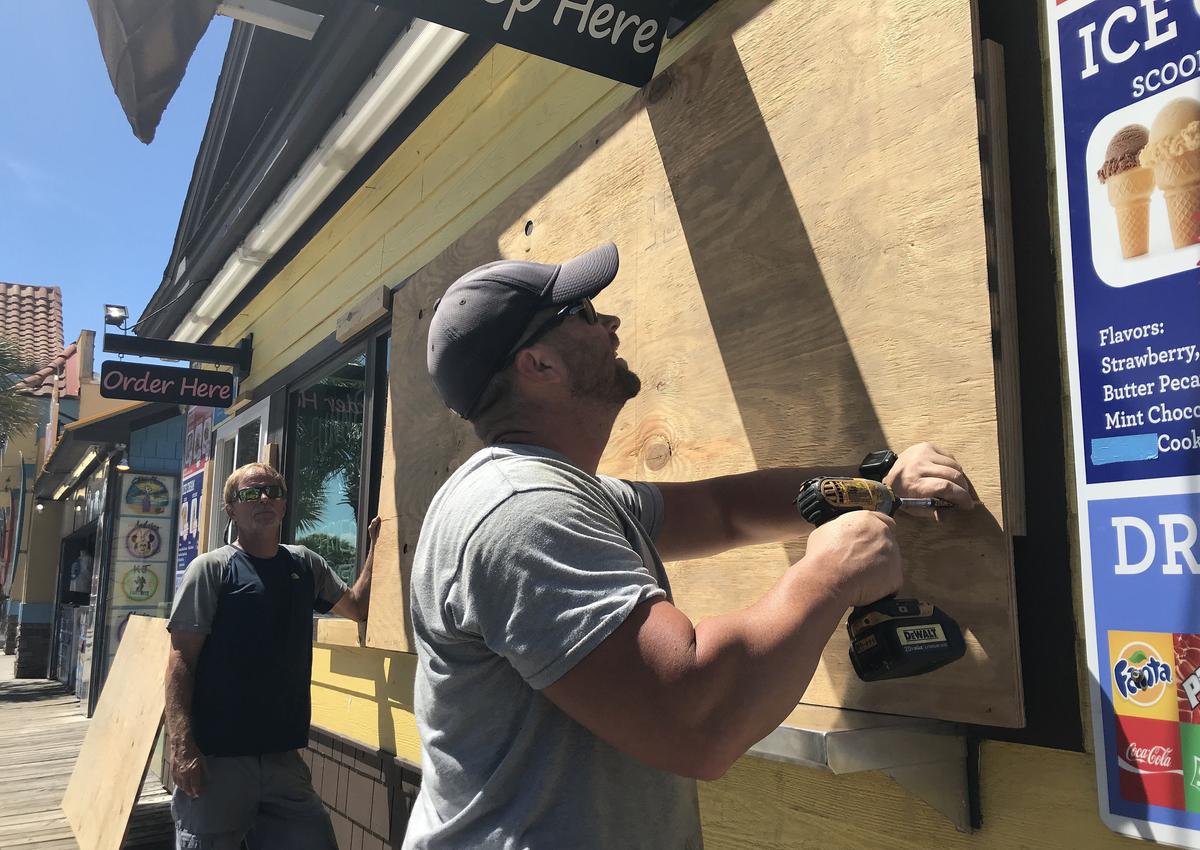 Scott Barfield and Glen Fowble board up the Freefall Park and ice-cream bar on Ocean Boulevard preparing for the arrival of Hurricane Florence as it storms towards the coast on Monday. September 10, 2018.
