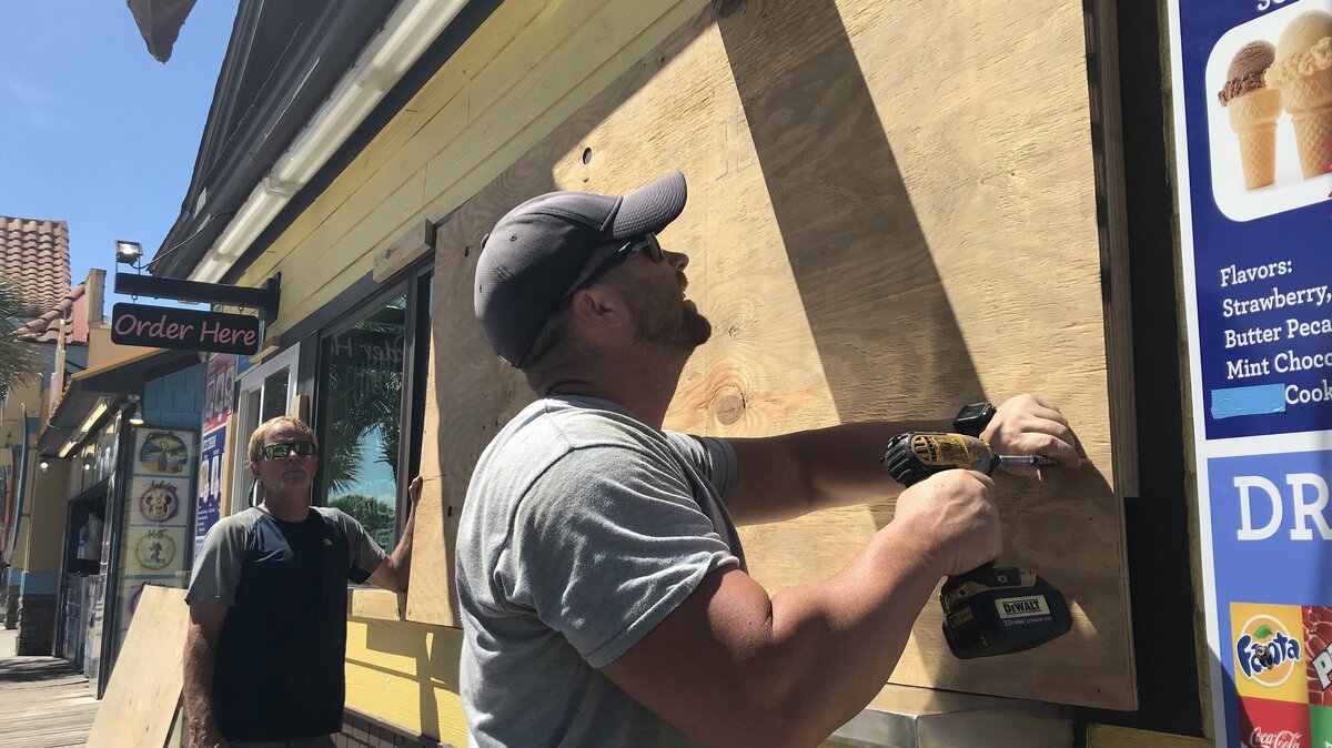 Scott Barfield and Glen Fowble board up the Freefall Park and ice-cream bar on Ocean Boulevard preparing for the arrival of Hurricane Florence as it storms towards the coast on Monday. September 10, 2018.