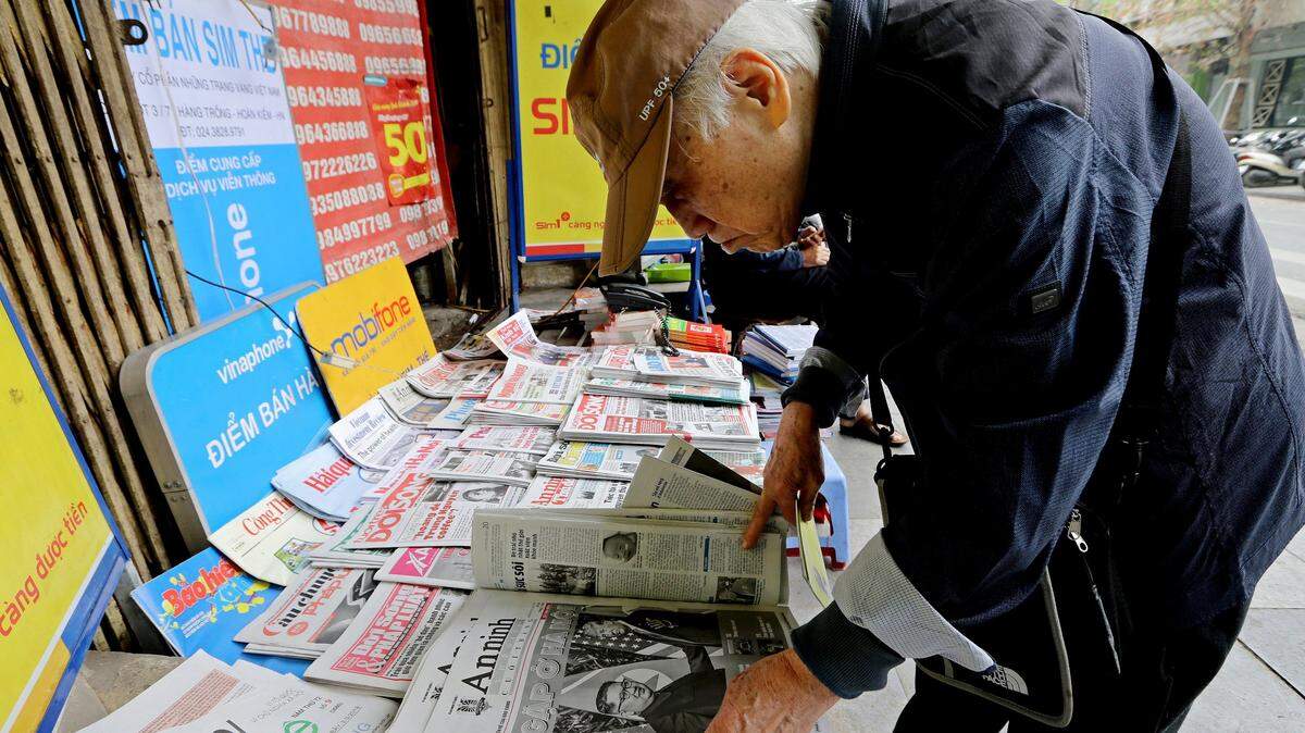 A man reads newspapers fronting U.S. President Donald Trump and North Korean leader Kim Jong Un at a newspaper stall Thursday, Feb. 28, 2019, in Hanoi. Trump and Kim cut short their second summit Thursday without reaching an agreement, a stunning collapse of talks that caused both leaders to leave their Vietnam meeting early and cancel a planned signing ceremony. (AP Photo/Minh Hoang)