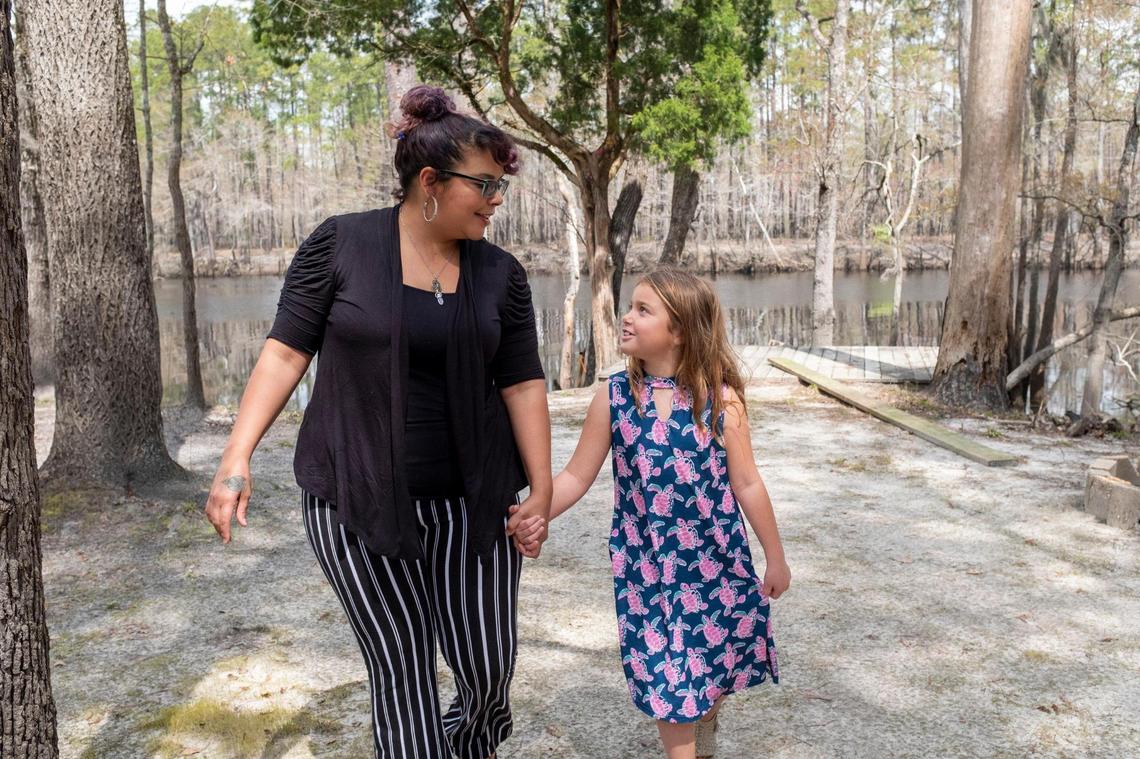 Tina McAfee and her 8-year-old daughter Zoie Sessions visit a river front area owned by her family at Lee’s Landing where they check for damage after the latest flood. This river area remains one of the family’s few refuges from the rapid development taking place along the S.C. 90 and Waccamaw River corridor. South Carolina Highway 90 is getting more congested with new home subdivisions cropping up at a rapid rate. Some local residents are concerned about the rate of growth and the impact on their community. March 24, 2021.