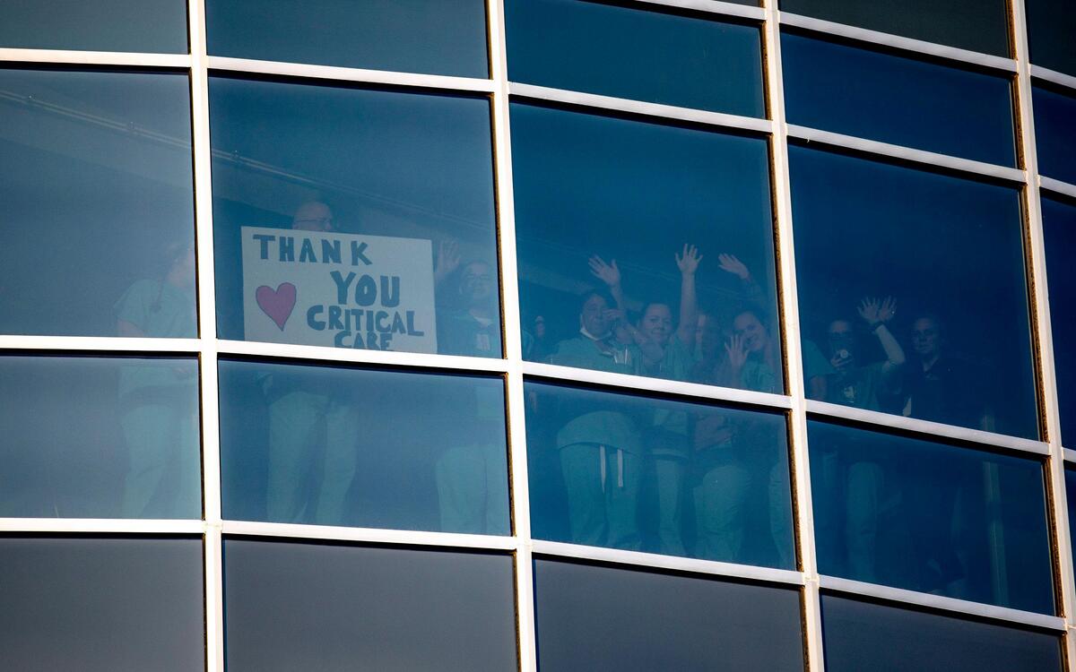Critical Care staffers at Tidelands Waccamaw Community Hospital wave to supporters below. A prayer vigil was held in the parking lot by hundreds of members of Belin Memorial UMC and members of the Murrells Inlet community on Thursday evening. April 2, 2020.