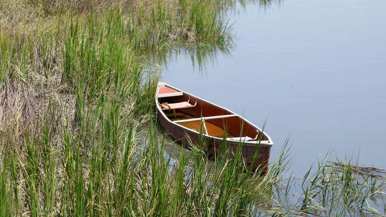 A red canoe has been floating in Murrells Inlet for 10 months. Who owned it?