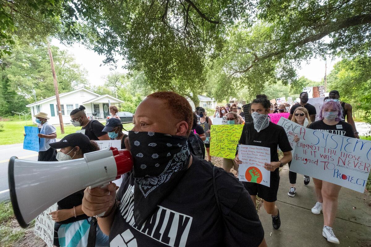 Evonne Sherman, a Coastal Carolina student, leads a protest march from Whittemore Park Middle School up Sixteenth Avenue on Saturday. Two peaceful protest and marches were held in Conway on Saturday with escorts from area law enforcement. June 6, 2020
