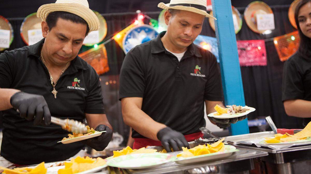 The crew from Fiesta Mexicana serves up traditional fare during the 33rd Annual Taste of the Town in 2016.