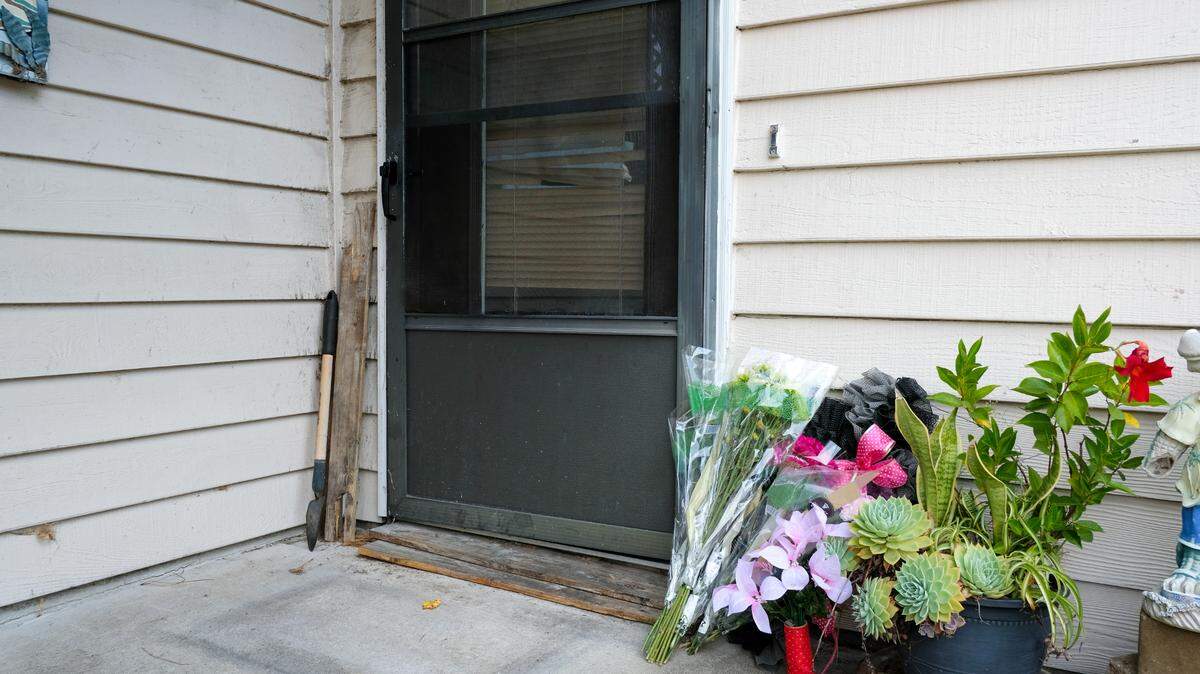 A makeshift memorial comprised of flowers left by friends and neighbors outside the front door of Kopacz’s condo.