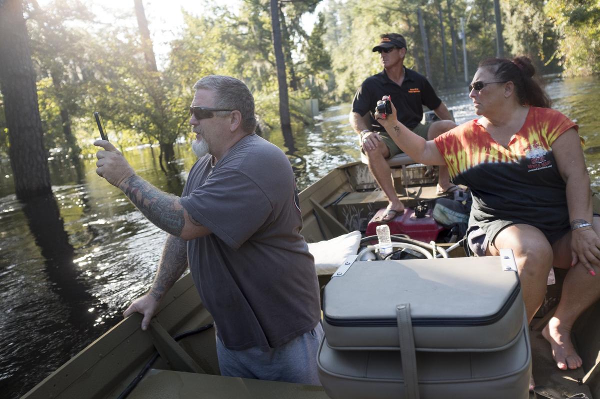 Sierra Abbott takes Gina Hanlon her husband Mike to their Lee’s Landing home in a jon boat on Wednesday. To thier relief, the couple found that the flood’s crest had not reached their home’s main level. The Waccamaw River at Conway crested Wednesday at well over 21 feet flooding many downtown homes. Wednesday, Sept. 26, 2018.