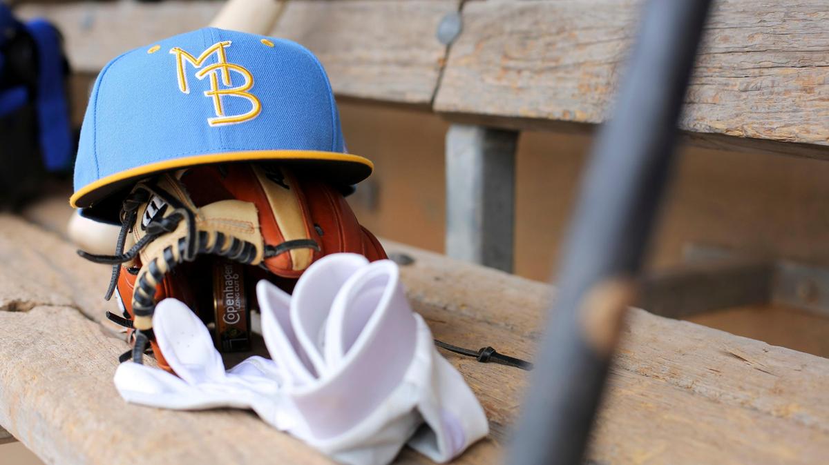 A ball cap and baseball mitt are in the dugout on Wednesday, Apr. 4, 2018, the eve of opening day at TicketReturn.com Field at Pelicans Ballpark.