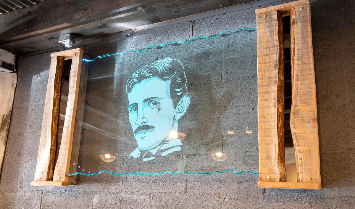 A glass portrait of Nikola Tesla inside the new High Voltage Barber Shop in Socastee.