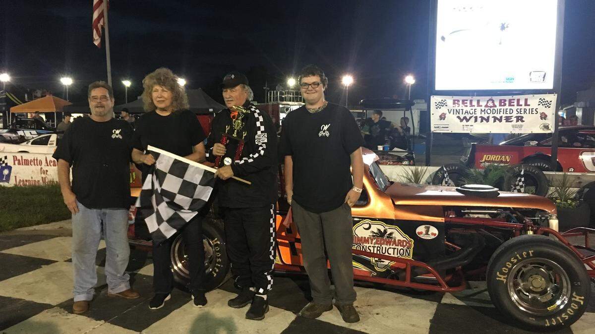 Bob Walker holds the checkered flag after winning at Vintage Series race at Myrtle Beach Speedway on Saturday night.