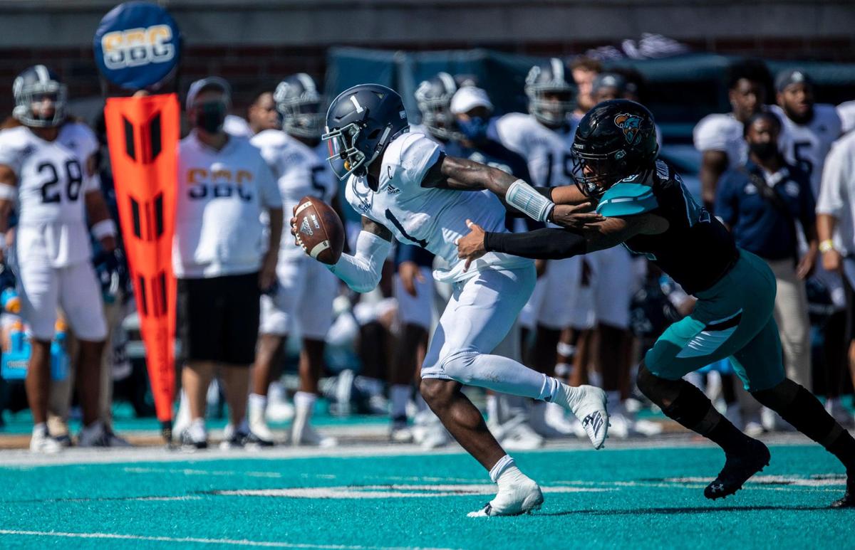 Georgia State QB Shai Werts tries to escape CCU linebacker Enock Makonzo. Coastal Carolina played its first game as a ranked FBS team against Georgia Southern on Saturday at Brooks Stadium in Conway. October 24, 2020.