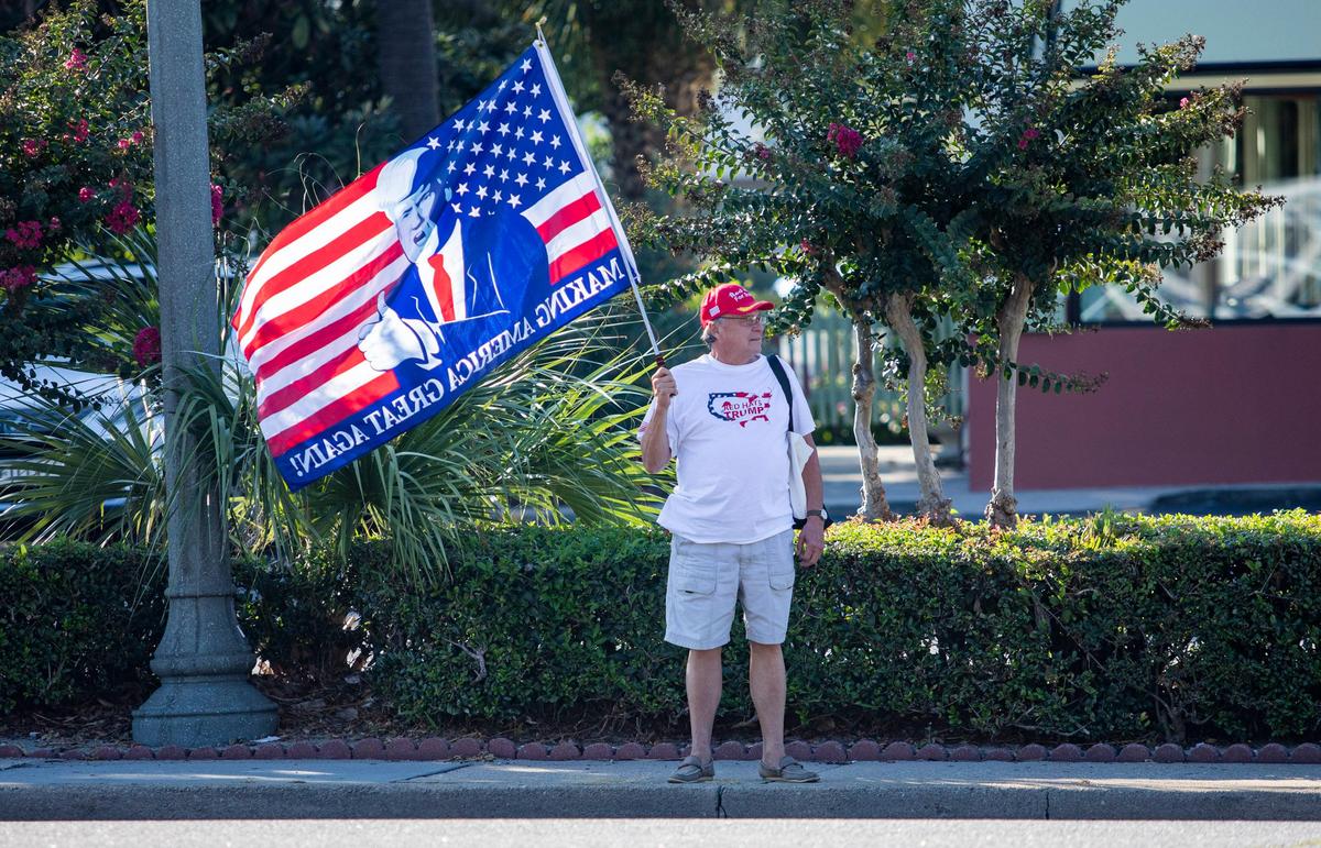 Don Bound, a Trump supporter from Myrtle Beach, holds up a “Make America Great Again” flag along Highway 17 across from Chapin Park before the start of a Bernie Sanders rally Thursday evening. Sanders made a stop in Myrtle Beach to talk about climate change.