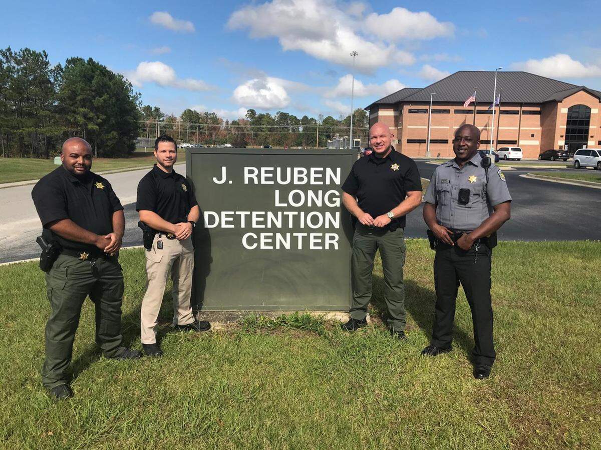 Former Horry County Sheriff’s Office Deputy Michael Bryant (furthest left) and Sgt. William “Bill” McMeins (second from right) resigned during May 2022 after an internal investigation found they each knowingly presented false information to a judge to obtain a warrant.
