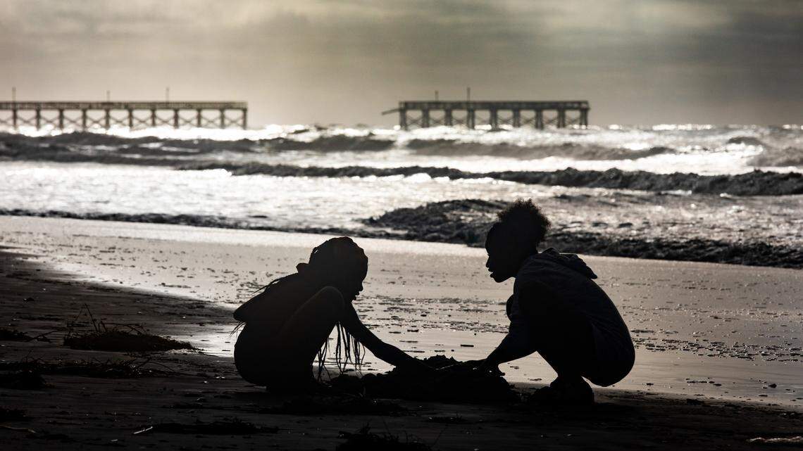 Children play on the beach near the storm damaged Sea Captains Pier on Tuesday morning hours after Hurricane Isaias passed. The storm surge from Hurricane Isaias combined with king tides damaged caused damage to the dunes in North Myrtle Beach and collapsed a section of the Sea Cabins Pier. August 4, 2020.
