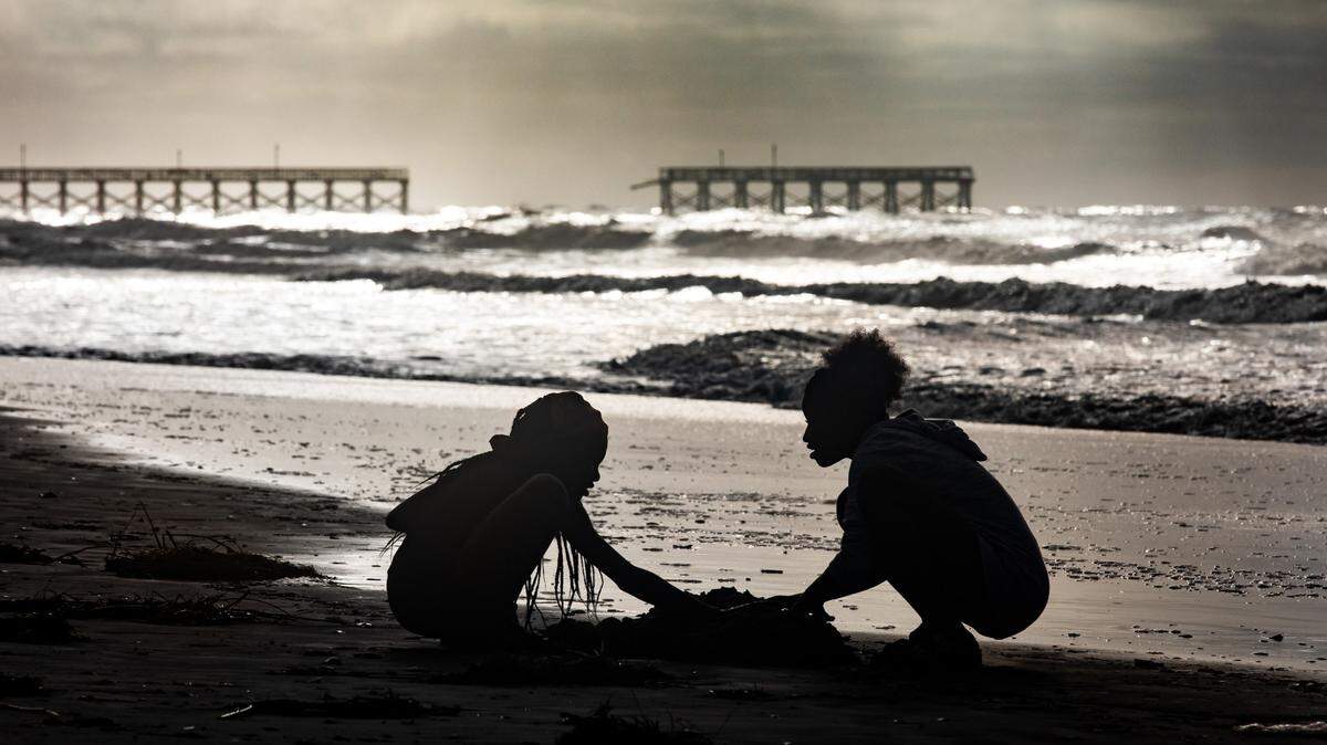Children play on the beach near the storm damaged Sea Captains Pier on Tuesday morning hours after Hurricane Isaias passed. The storm surge from Hurricane Isaias combined with king tides damaged caused damage to the dunes in North Myrtle Beach and collapsed a section of the Sea Cabins Pier. August 4, 2020.