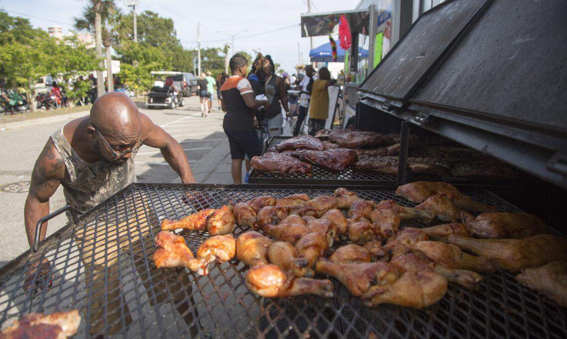 Nathan Quick of Greensboro, N.C. checks on his ribs on 30th Avenue South in Atlantic Beach during BikeFest on May 26, 2018.