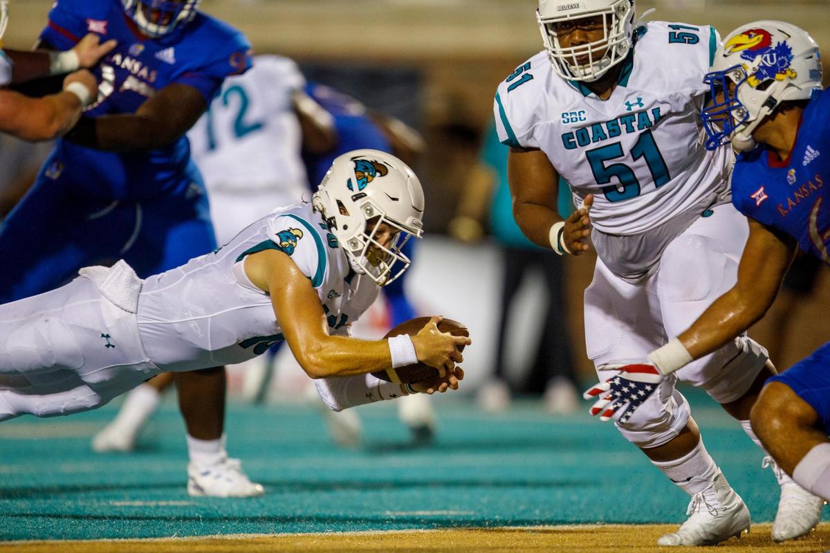 Coastal’s Grayson McCall dives for the end zone to score in the first half against Kansas. The Coastal Carolina Chanticleers hosted Kansas at Brooks Stadium on Friday night, Aug. 11, 2021.