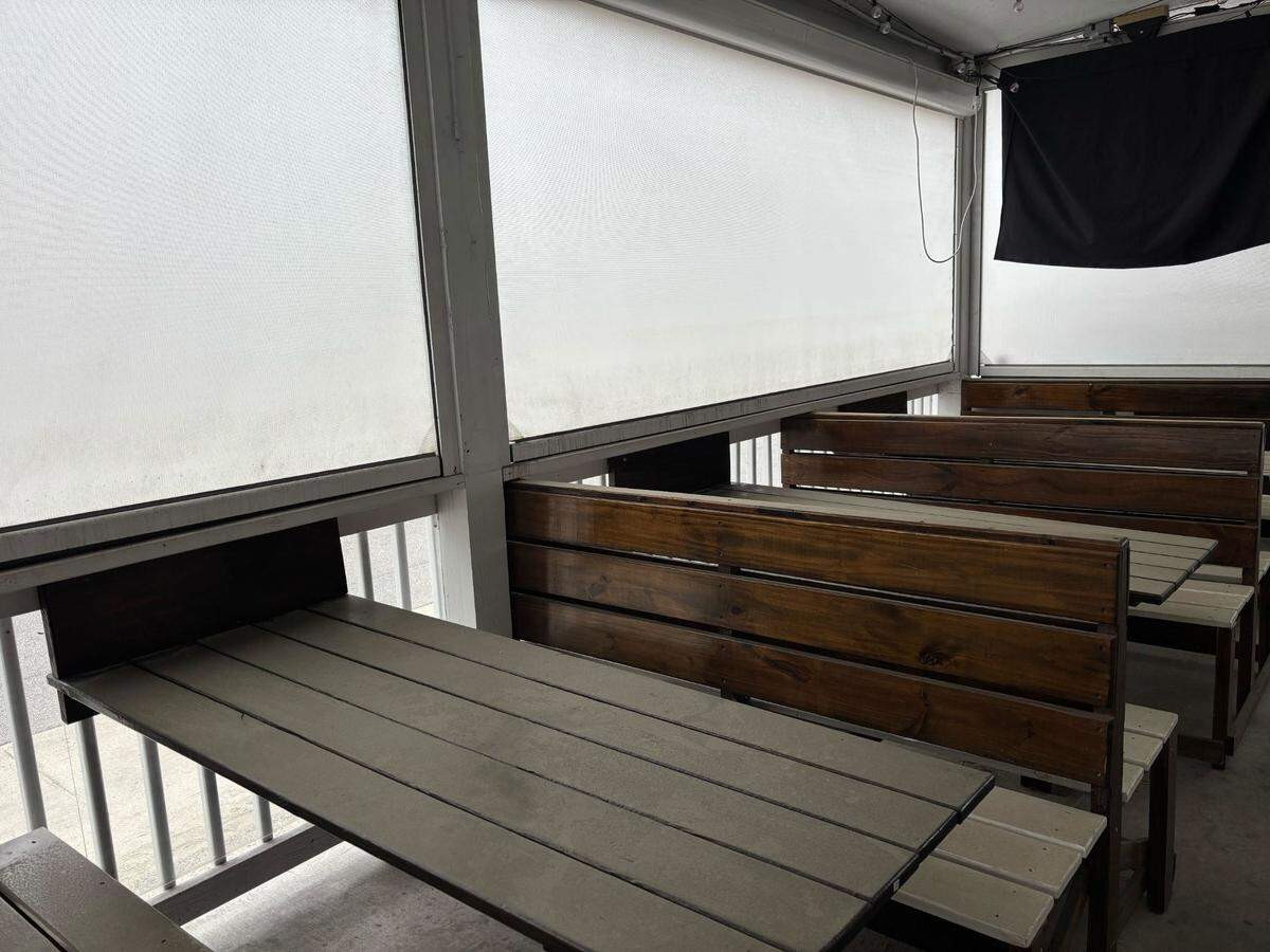 The benches and tables at The Twisted Penguin had a thick coat of dirt and dust. The restaurant said it would close temporarily in February. May 26, 2025