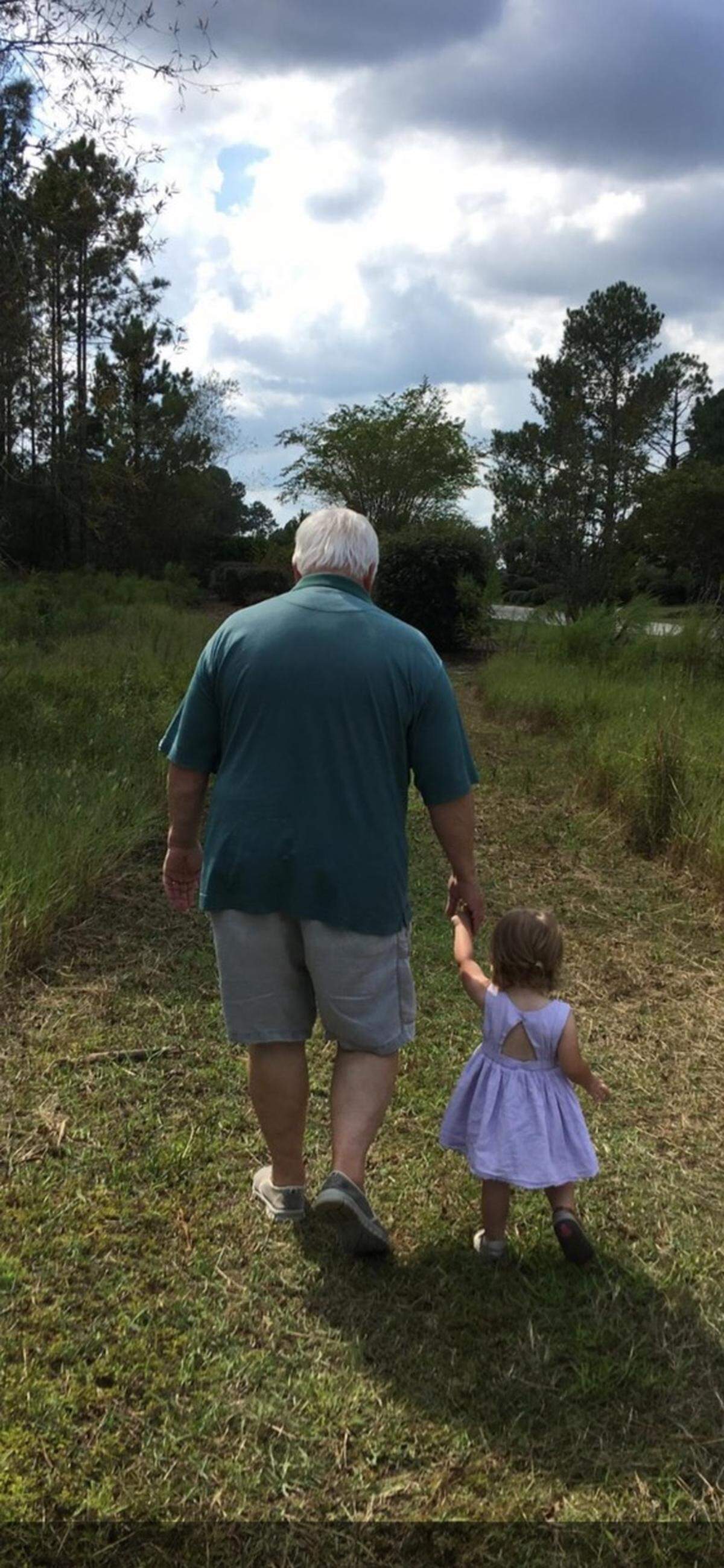 Former Myrtle Beach area golf course developer, owner and operator Larry Young with a great-granddaughter. Young died on Wednesday.