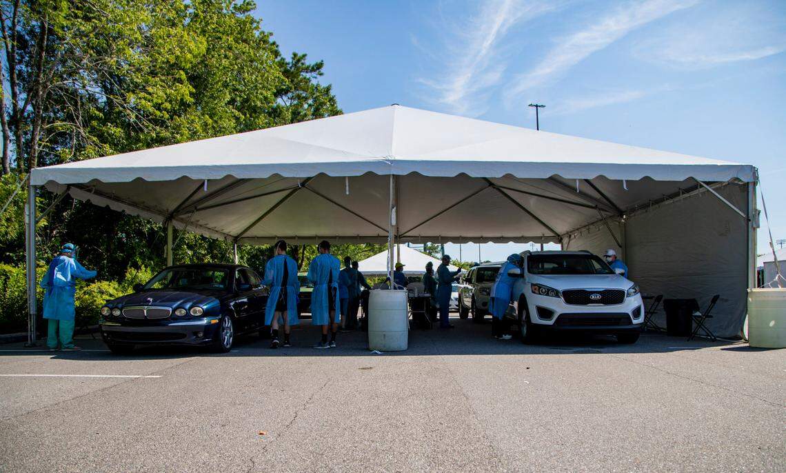 Tidelands Health medical professionals conduct a drive-through COVID-19 testing site in July at Myrtle Beach Pelicans Ballpark.