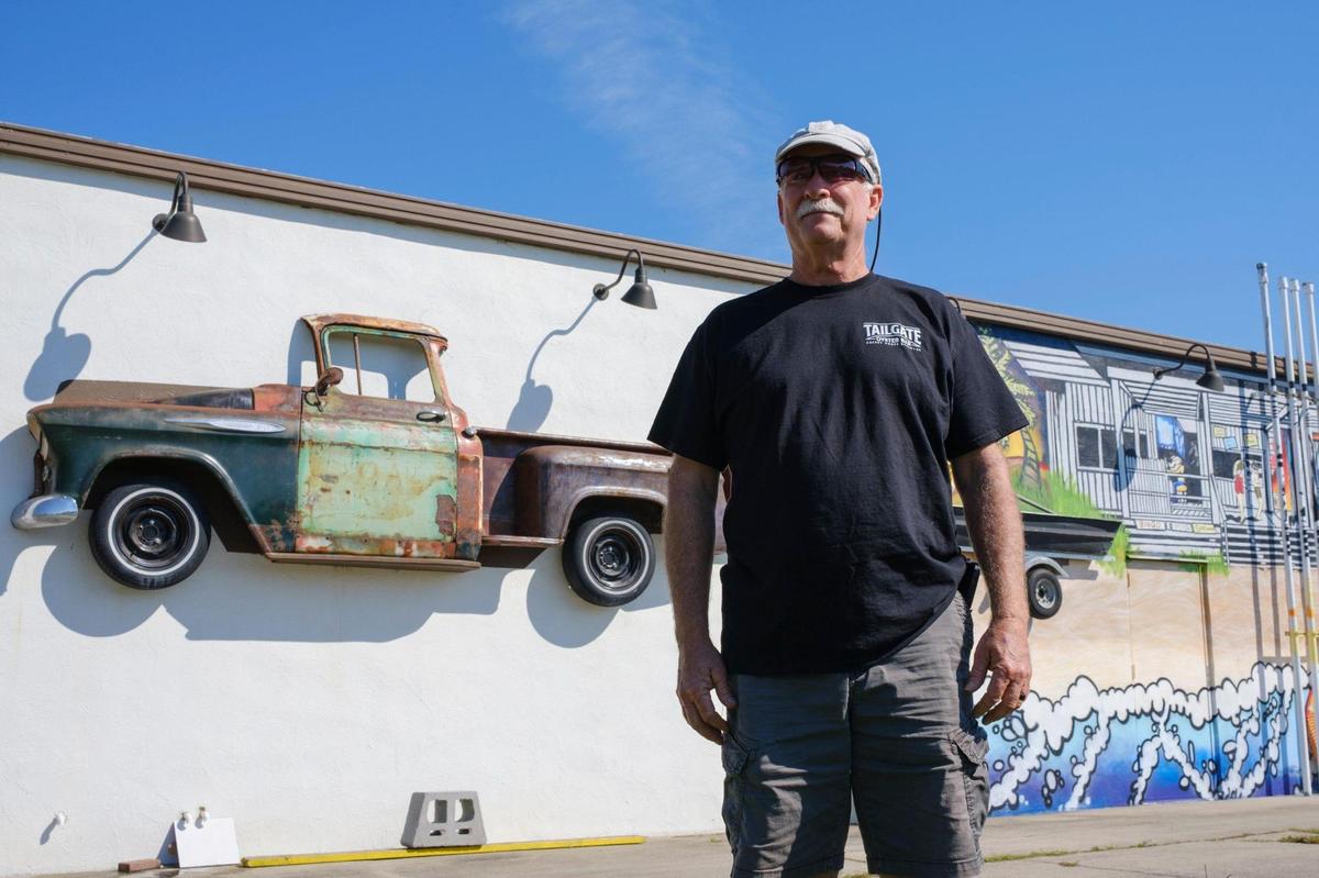Robert Attaway stands in front of the mural he commissioned on the side of his building at the Tailgate Oyster Bar at 513 Sea Mountain Highway in North Myrtle Beach. In addition to the raw and steamed oysters, the restaurant decor will feature classic car tailgates and bumpers, an old-school jukebox and photos of Grand Strand music and dance venues from the past. Sept. 28, 2021.
