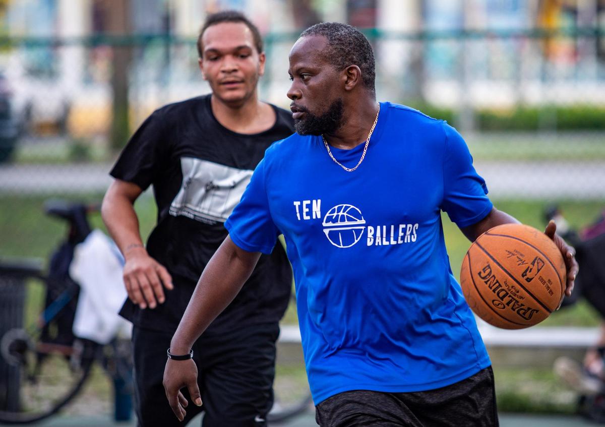 Wes Chestnut dribbles across the court as Myrtle Beach residents participate in a game of pick-up basketball on the basketball court at Midway Park in Myrtle Beach Sunday afternoon.