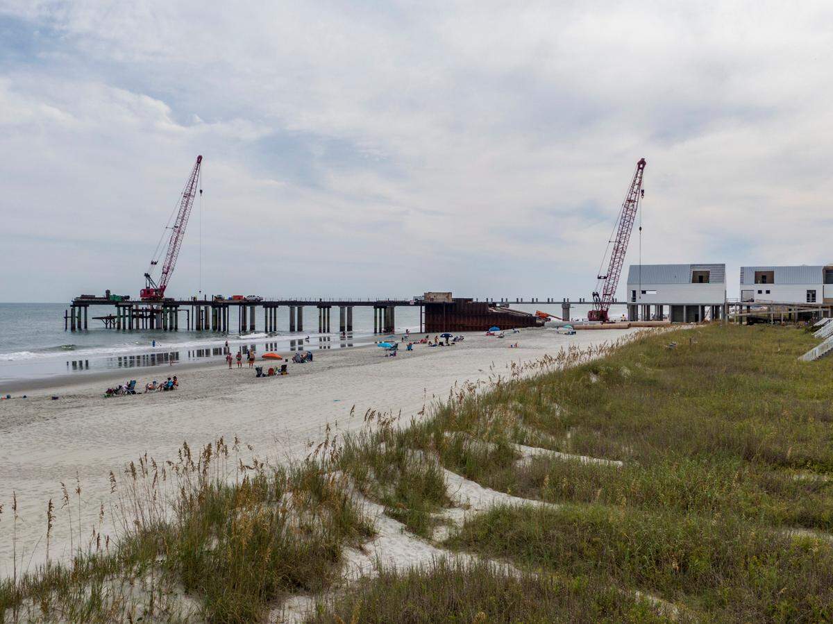 Construction of a new $20 million dollar Surfside Beach Pier is ongoing after multiple delays and is now expected to re-open by the Spring of 2023. The former pier was sheared in half by Hurricane Matthew in 2016. The new construction includes space for four merchants in three buildings with a pavilion near the end of the pier. September 27, 2022.