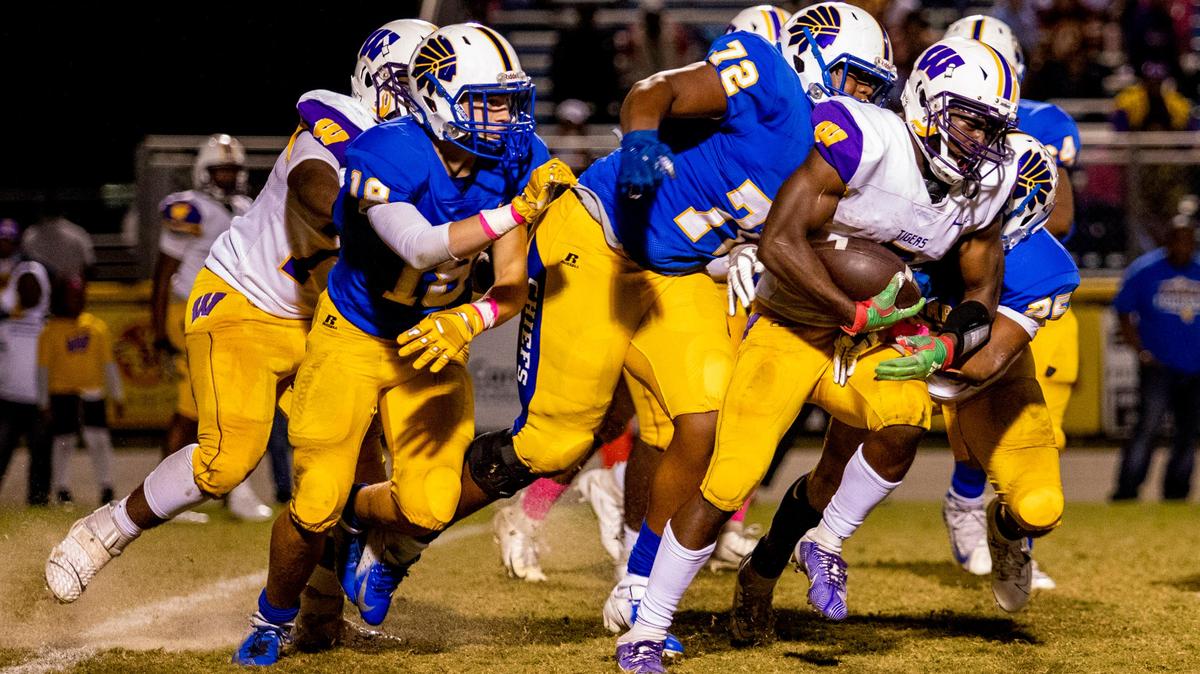Wilson Tigers senior running back Yavin Smith runs the ball against the North Myrtle Beach Chiefs Friday night in Little River.