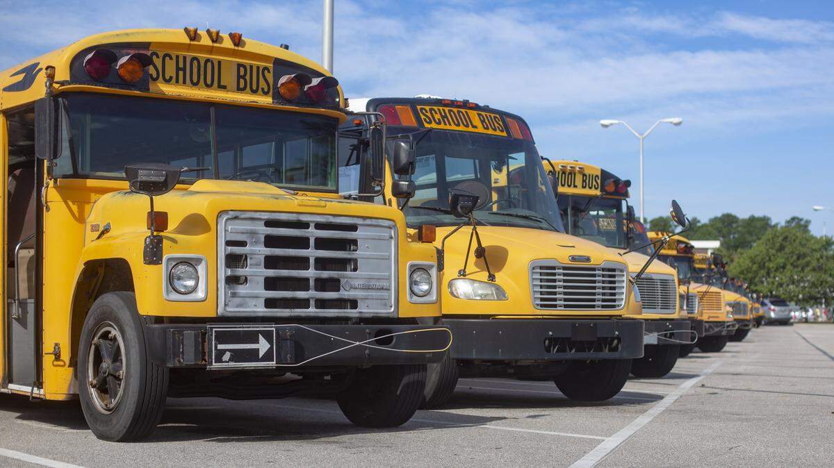 School buses sit lined up at North Myrtle Beach High School.