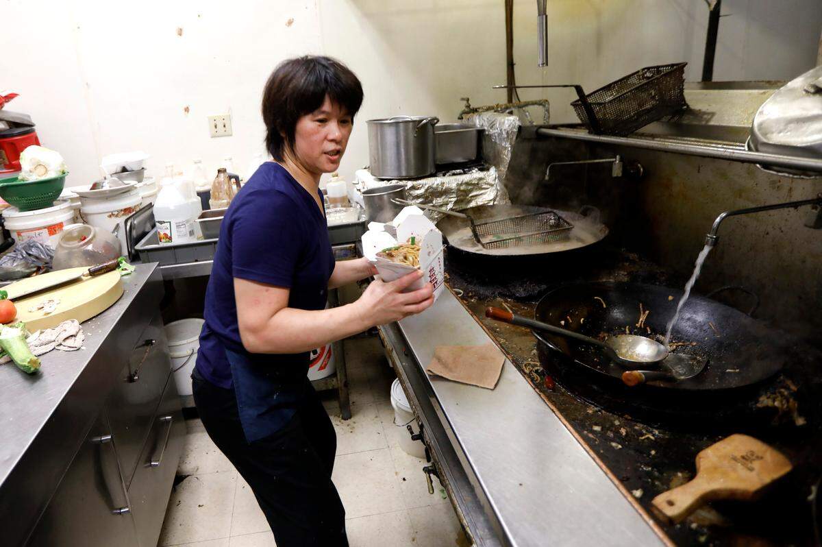 Jennifer Koo puts meals together at Wok Express on North Kings Highway in Myrtle Beach, S.C., Friday, Sept. 14, 2018. 