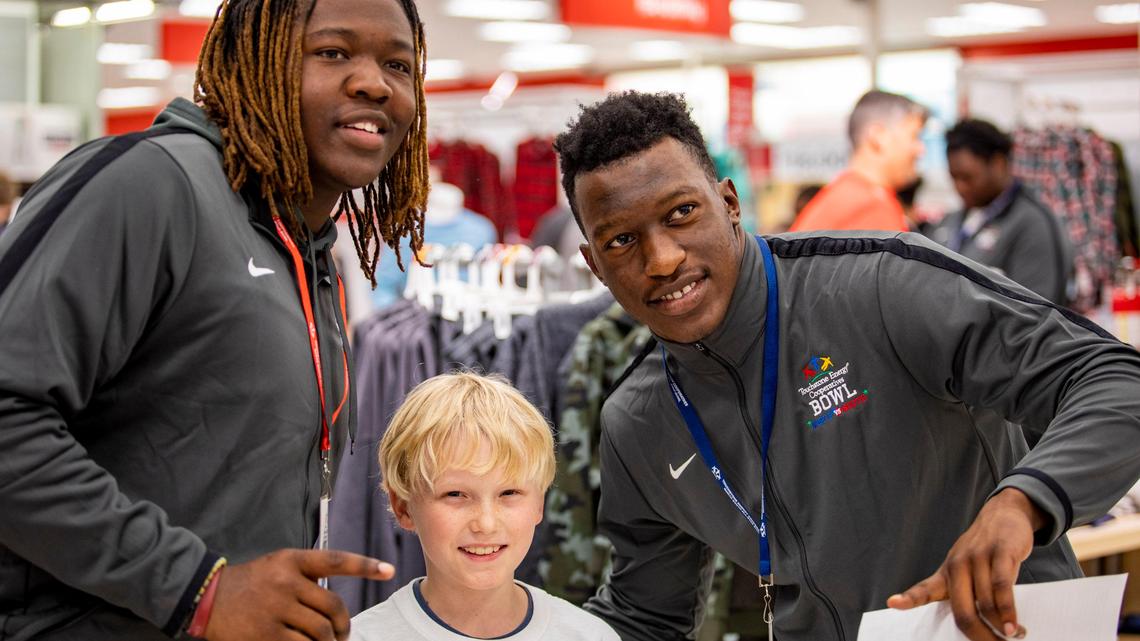High school football players team up with kids for shopping spree at Target