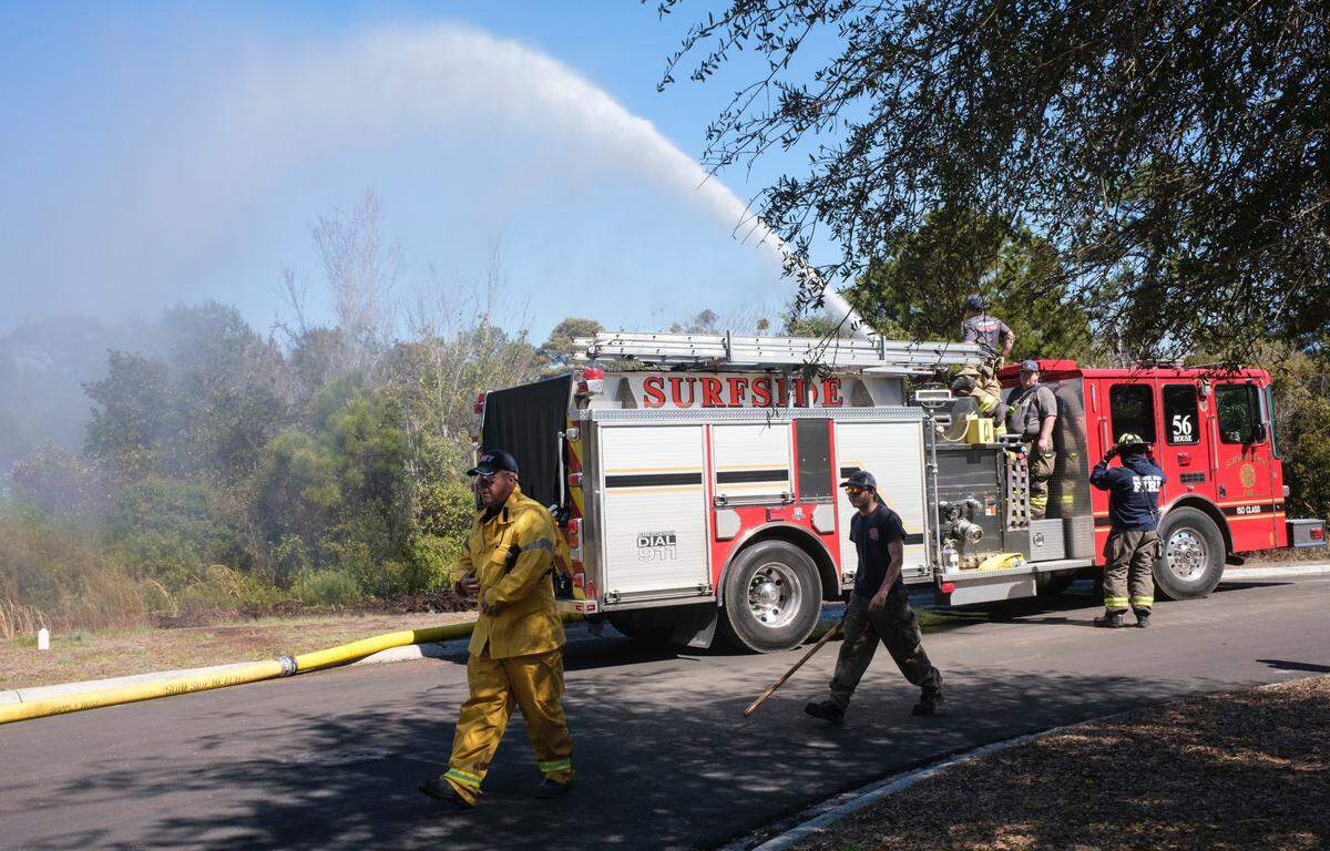 The Carolina Forest fire had burned more than 1600 acres by day three on Monday, March 3, 2025, and was 30 percent contained. Firefighters from around the region dug fire breaks around communities and responded to hot spots while aircraft dropped water on the flames.