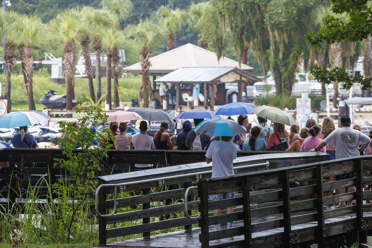 Despite rain storms, crowds gather on the waterfront walkways of Swing Bridge Park in Socastee hoping to catch a glimpse of actors in the Netflix TV show “Outer Banks.” Earlier on Tuesday, Madelyn Cline (Sarah) and Chase Stokes (John B.) could be seen running across the bridge during filming this past summer.