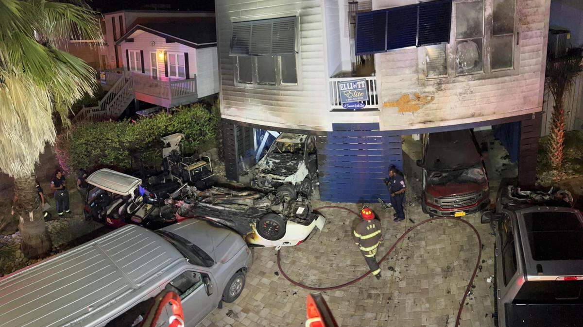 A fiery crash left two people hospitalized after the fire spread to a nearby house and five vehicles in North Myrtle Beach on North Ocean Boulevard Sunday.