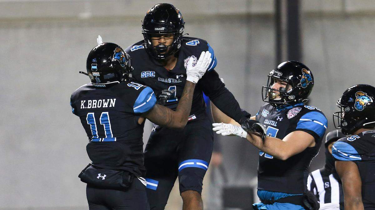 Coastal Carolina tight end Isaiah Likely (4) celebrates with wide receiver Kameron Brown (11) and tight end Michael McFarlane (87) after scoring a touchdown against Liberty during the 2020 Cure Bowl on Dec. 26, 2020, in Orlando, Florida