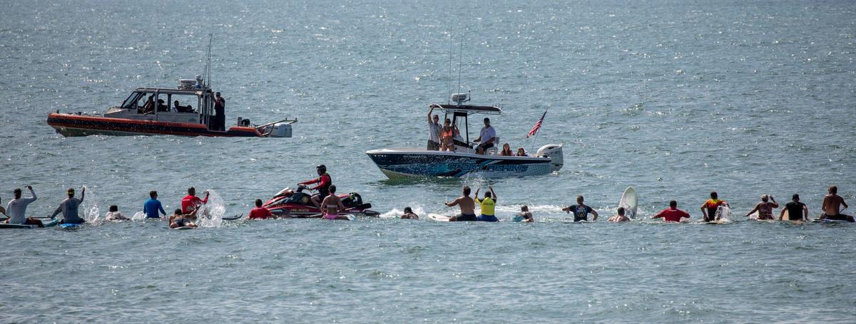 A paddle out ceremony and celebration of life was held on the beach in Garden City on Saturday for Lt. Matthew A. Piontkowski who died of cancer on June 9, 2023. Fellow firefighters, police officers, friends and family joined in the traditional ceremony that included paddling surfboards out into a circle, sharing remembrances and places flowers in the water in his honor. July 15, 2023.