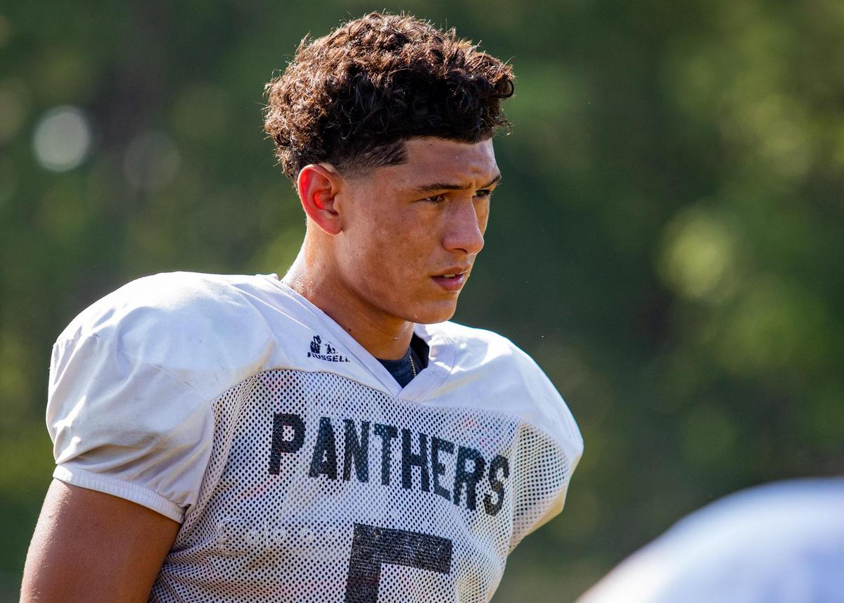 Carolina Forest senior quarterback Mason Garcia takes a breather during football practice at Carolina Forest High School Friday afternoon.
