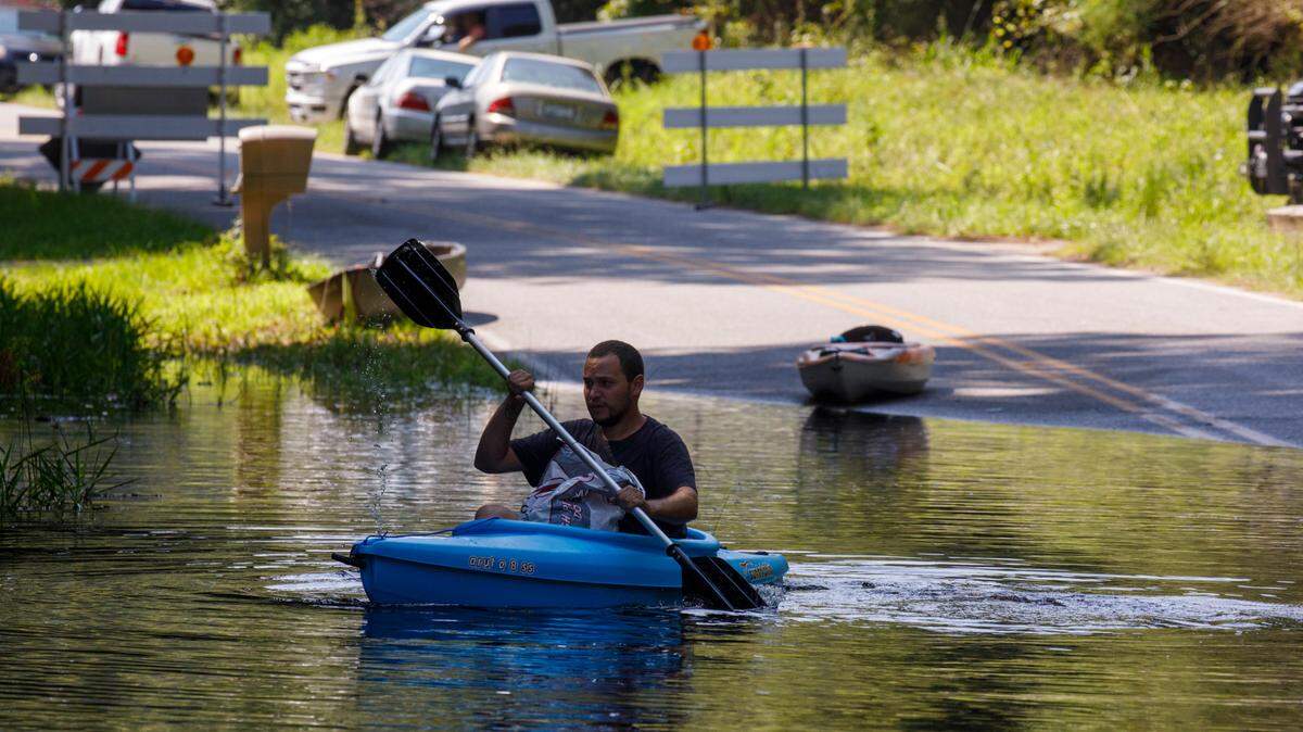 Isaac Laplante uses a kayak to access his home in the Lee’s Landing community. The Waccamaw River at Conway reached the major flood stage of over 14 feet on Friday following Tropical Storm Debby’s rains. The river is expected to crest this weekend. Aug. 16, 2024.