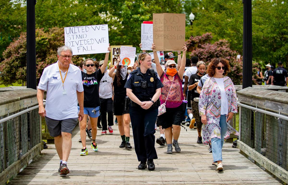 Myrtle Beach City Manager John Pedersen, Myrtle Beach Chief of Police Amy Prock and Mayor Brenda Bethune lead protesters in a march around Grand Park at Market Common Sunday afternoon.