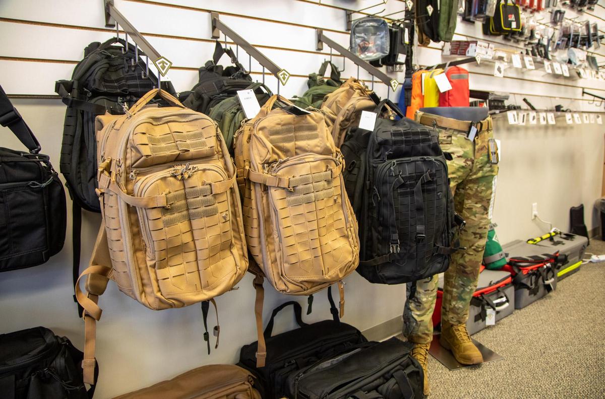 Tactical backpacks hang along the wall at Cormac Arms & Outfitters on 38th Avenue in Myrtle Beach. In addition to gun sales and apparel, the new tactical shop supplies law enforcement agencies with tactical gear.