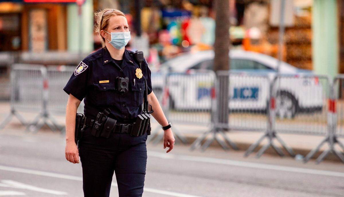 A police officer dons a mask in the Grand Strand area.