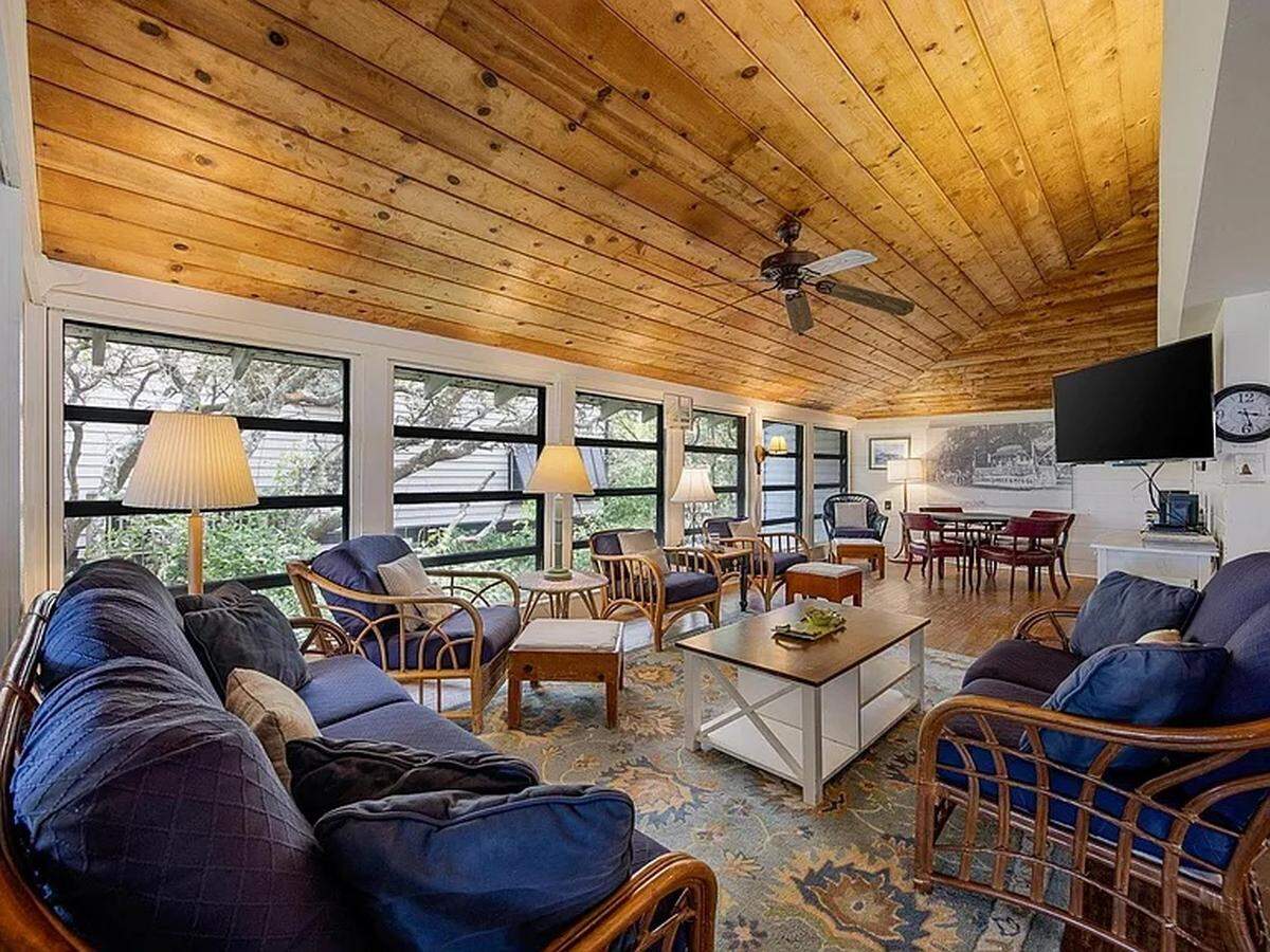 The living room of a Pawleys Island home for sale, which was built in 1935. The house has a view of both the ocean and nearby wetlands and marshes.