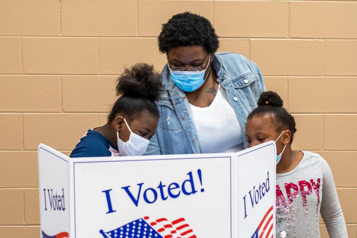 Kylinda Simmons with daughters Kymya (10) and Kyema Simmons (8) vote at the Mary C. Canty Recreation Center on Tuesday afternoon. ““With my children growing up and discussing things in school, it was a must,” Simmons said of coming out to vote today. Voters went to polling places throughout Horry County, S.C. today to vote in local and national elections. Poll workers, wearing face shields and taking precautions, reported a strong turnout of in-person voting despite concerns over the coronavirus pandemic. November 3, 2020.