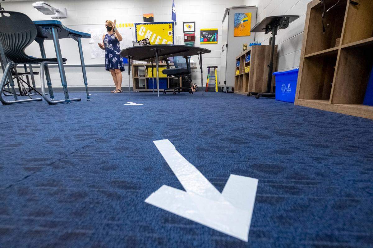 Eighth grade math teacher, Sharon Mahon stands in her classroom where desks have been spaced apart and arrows placed on the floor to direct student movement. Teachers returned to North Myrtle Beach Middle School on Thursday and are preparing for the eventual re-opening after having been closed due to the coronavirus threat. August 27, 2020.