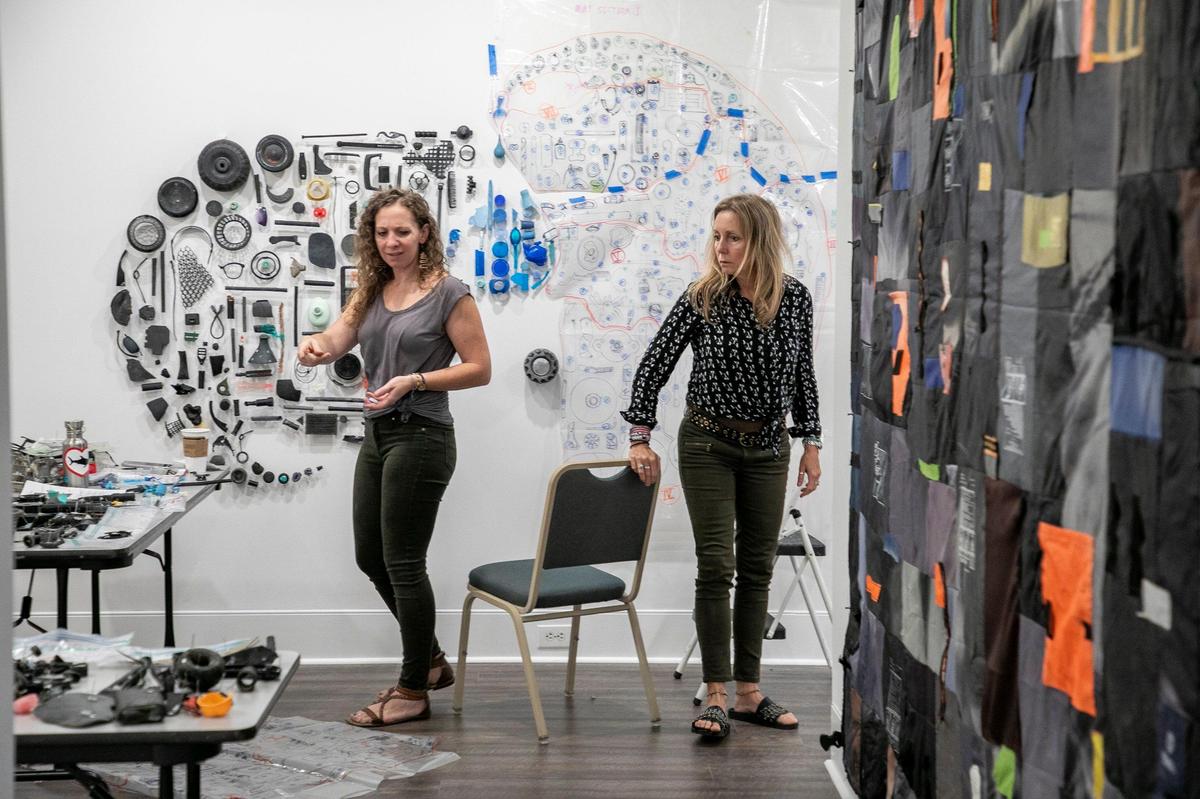 Artist Pam Longobardi (right) with assistant Susan Knippenberg work to hang the artist’s exhibit at the Franklin G. Burroughs-Simeon B Chapin Art Museum. Longobardi is one of six artists featured in the “Can’t You Sea? Ocean Artifact Exhibit from June 15 to September 8, 2019.