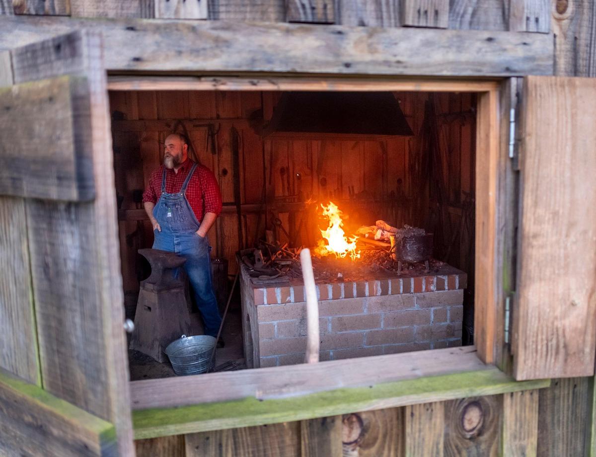 Horry County Museum Director Walter Hill explains the workings of the blacksmith’s forge during Tobacco History Day at the L.W. Paul Living History Farm on Saturday with visitors getting the chance to participate in the cropping and curing of the leaf using traditional farming methods. Horry County Museum’s 17-acre farm depicts farm life in the county from 1900 to 1955. The farm is located off of Harris Shortcut Rd. outside of Conway. Farm events are free to the public.