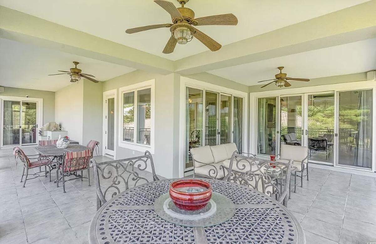 A Mediterranean home is listed for $2.6 million on Zillow. The house, which is in the gated Grand Dunes community, has a large deck and a summer kitchen.