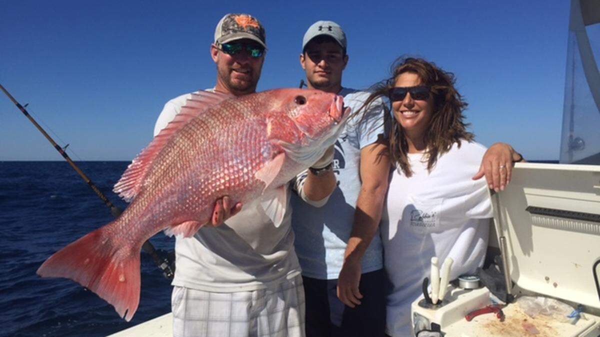 Capt. Jay Sconyers, Grant Stadler and Amy Armstrong Stadler show off a red snapper in the 20-pound range caught with Aces Up Fishing during the 2017 red snapper season last November.