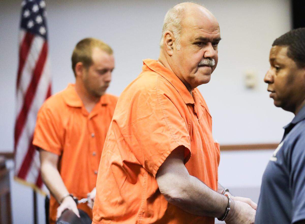Stephen Flood (foreground) and Joshua Bishop leave a Marion County courtroom after a bond hearing. The two ex-Sheriff’s deputies were charged with involuntary manslaughter for their roles in the drowning of two women in an Horry County Sheriff’s van swept up in floodwaters.