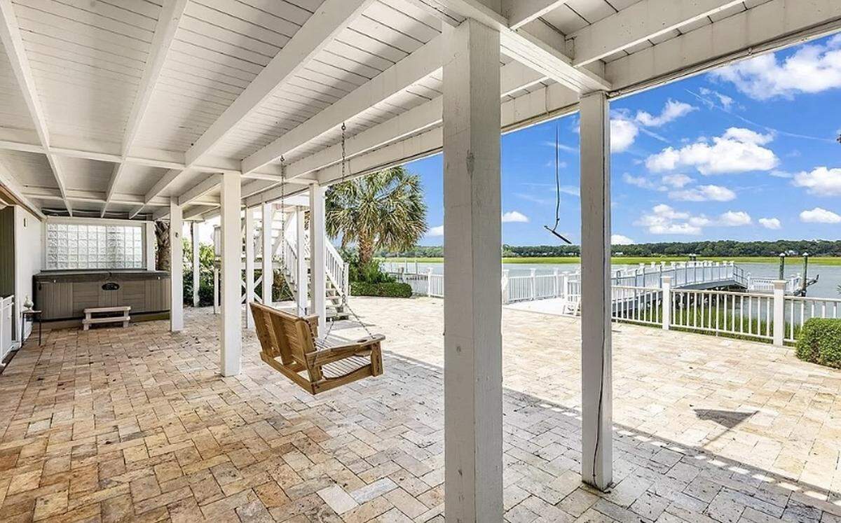 A $1.7 million house is listed for sale on Zillow. The home in North Myrtle Beach is nestled between 30-foot palm trees and features an elevator and dock.